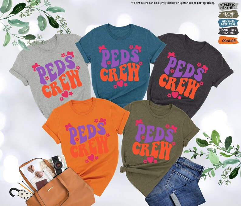 May include: Five t-shirts with the text "PEDS CREW" in a retro font. The shirts are in various colors, including grey, teal, dark grey, orange, and olive green. The text is in purple and orange.