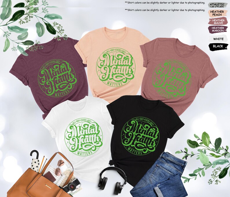 May include: Five different color t-shirts with a green graphic that says "All Day Every Day Mental Health Matters".