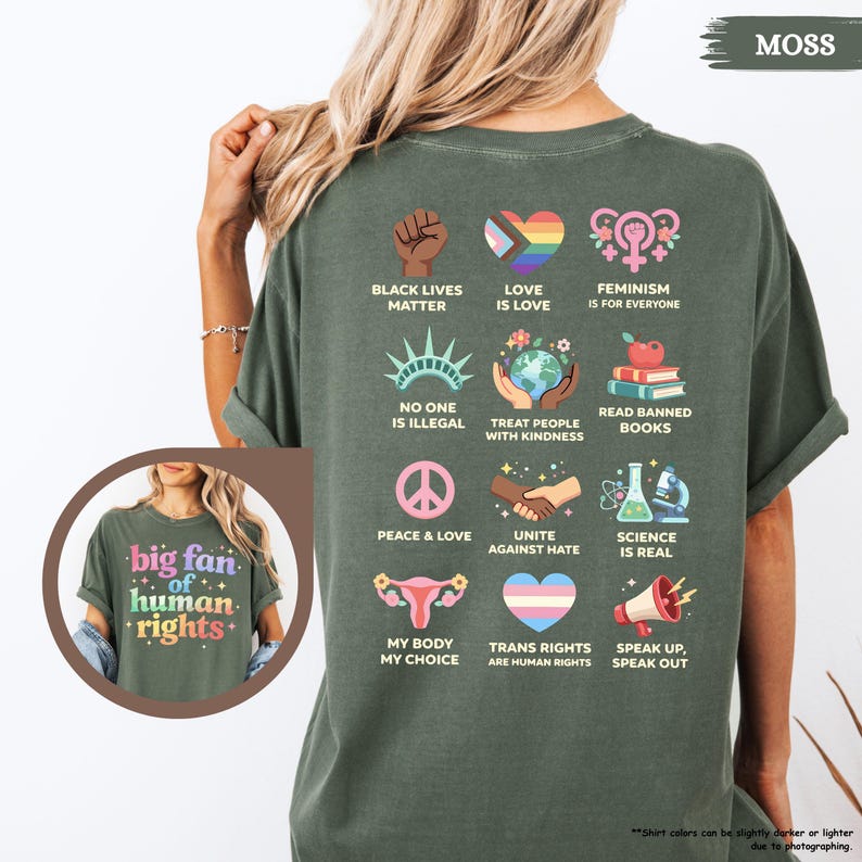 May include: Moss green t-shirt with a graphic of various social justice symbols and phrases, including "Black Lives Matter," a rainbow heart, and "Feminism is for Everyone." The shirt also features the text "big fan of human rights."