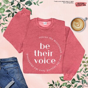 a red sweatshirt with the words be their voice on it