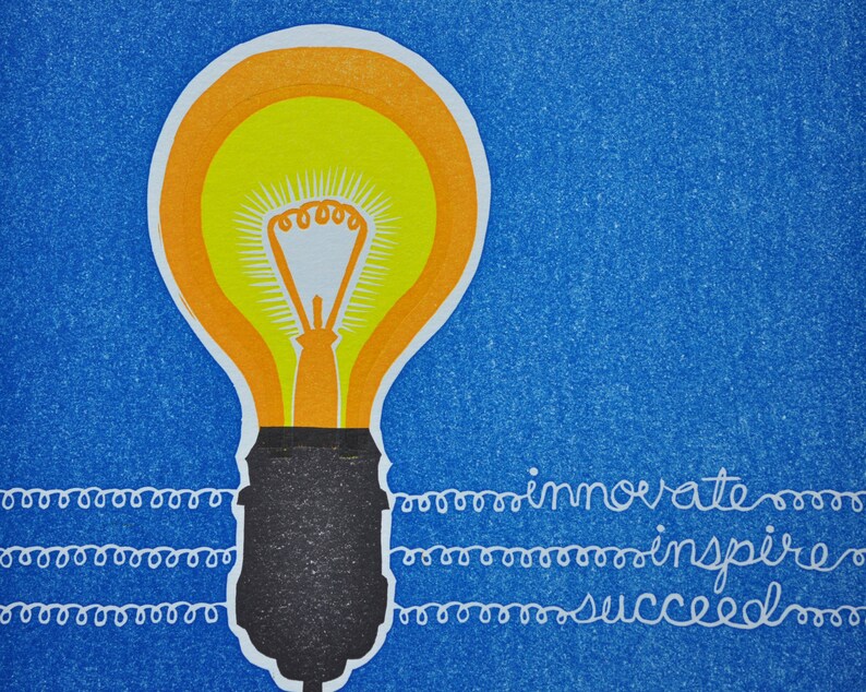 May include: A yellow light bulb with an orange outline on a blue background. The words "innovate", "inspire", and "succeed" are written in white cursive below the light bulb.