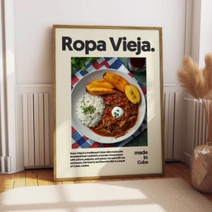 May include: A poster with a photo of Ropa Vieja, a traditional Cuban dish made with shredded beef, rice, and plantains. The poster has the text "Ropa Vieja" in large black letters at the top and the text "made in Cuba" at the bottom.