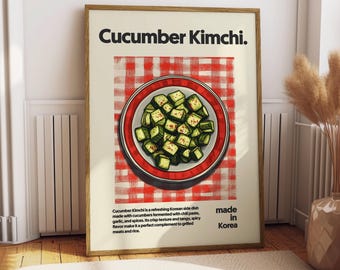 May include: A poster with a red and white checkered background and a white plate with green cucumber kimchi on it. The poster has the text "Cucumber Kimchi" in black text at the top and "made in Korea" in black text at the bottom.