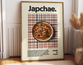 May include: A framed poster with a red and black checkered background. The poster features a bowl of Japchae, a popular Korean dish made with stir-fried glass noodles, vegetables, and often beef. The text "Japchae." is in bold black font at the top of the poster. The text "made in Korea" is in black font at the bottom of the poster.