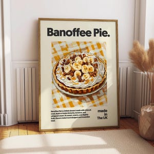 May include: A poster with a yellow and white checkered background featuring a close-up of a Banoffee Pie. The pie is topped with whipped cream, bananas, and chocolate. The text "Banoffee Pie." is in bold black letters at the top of the poster. The text "made in The UK" is in black letters at the bottom of the poster.