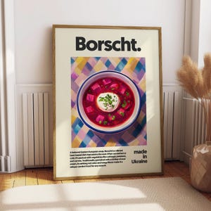 Peut inclure: Une affiche avec une illustration vibrante en rouge et blanc d'un bol de soupe borscht. L'affiche porte le texte "Borscht. made in Ukraine" en noir.