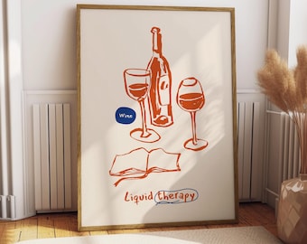 May include: A framed art print featuring a wine-themed illustration. The artwork depicts a wine bottle, two wine glasses, and an open book, all in a reddish-orange color. The words "Wine" and "Liquid Therapy" are also included.