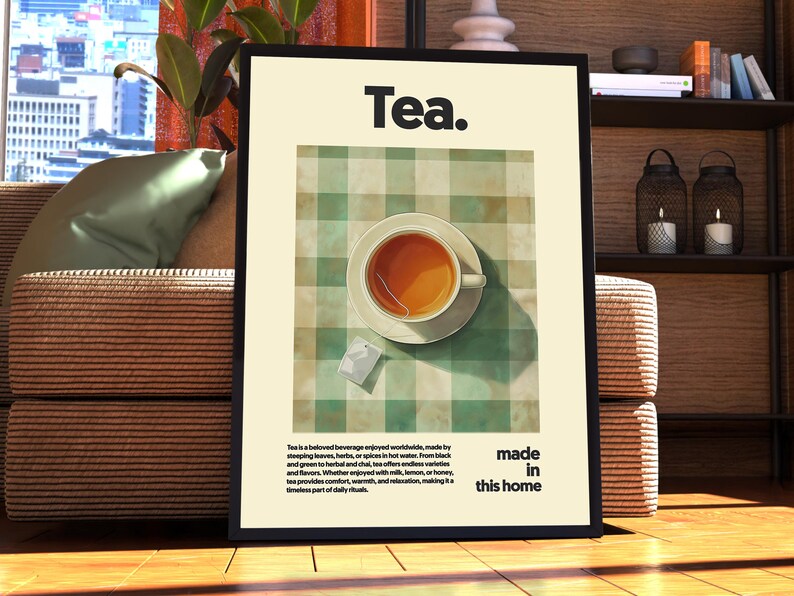May include: A framed poster with the word "Tea." in bold black text. The poster features a green and white checkered tablecloth with a cup of tea and a tea bag on a white saucer. The text below the image reads "Tea is a beloved beverage enjoyed worldwide, made by steeping leaves, herbs, or spices in hot water. From black and green tea to herbal and chai, tea offers endless varieties and flavors.  With countless ways to enjoy it, with milk, lemon, or honey, tea provides comfort, warmth, and relaxation, making it a timeless part of daily rituals. Made in this home."