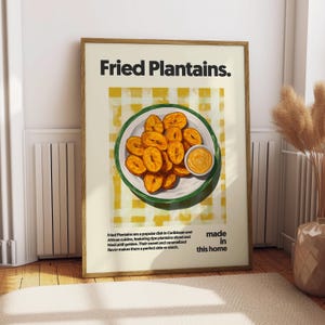 May include: A poster with a yellow and white checkered background featuring a plate of fried plantains with a small dish of dipping sauce. The text "Fried Plantains" is in bold black letters at the top of the poster. The text "made in this home" is in black letters at the bottom of the poster.