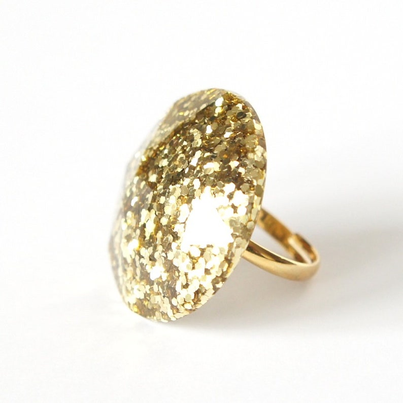 Round Resin Ring Abstract chunky large gem gemstone statement costume piece in gold glitter.