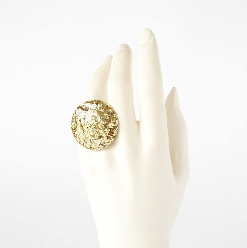 Round Resin Ring Abstract chunky large gem gemstone statement costume piece in gold glitter.