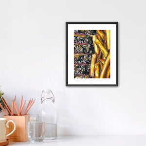 May include: A framed art print featuring a close-up of a pile of golden-yellow french fries. The fries are painted with textured brushstrokes, and the artwork is set against a dark background. The frame is black.