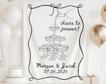 May include: Black and white illustration of a champagne bottle pouring into a pyramid of champagne glasses. The text "Cheers to forever!" is written above the glasses. Below the glasses, the text "Morgan & Jacob 07.05.2025" is written.