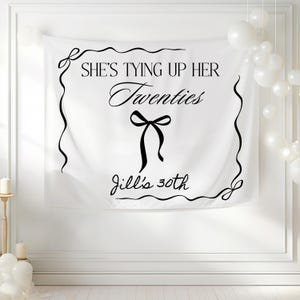Tying up her twenties 30th birthday banner