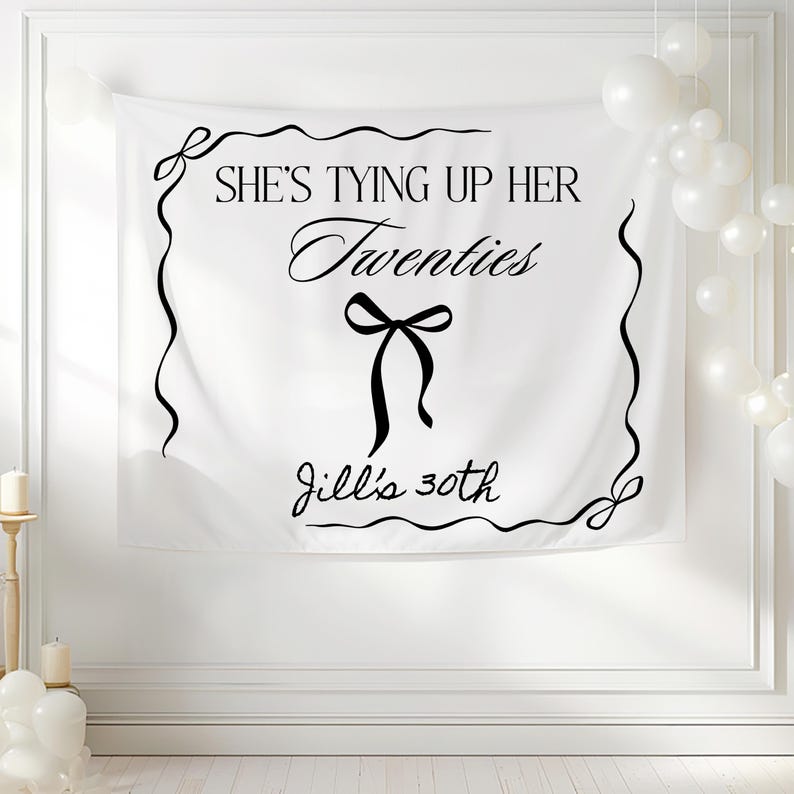 Tying up her twenties 30th birthday banner