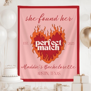 May include: Pink bachelorette party banner with a red heart with flames and the text "she found her perfect match" with the years "EST. 2025" on either side of the heart. The banner also has the text "Maddie's Bachelorette Austin, Texas".