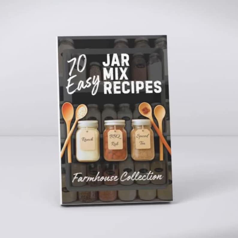 May include: A cookbook cover with the title "70 Easy Jar Mix Recipes." The cover features three glass jars with labels for Ranch, BBQ Rub, and Spiced Tea, along with wooden spoons. The words "Farmhouse Collection" are at the bottom.