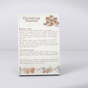 May include: A white instructional page titled Finishing Touches featuring text about decorating jars with fabric, twine, and natural elements. The page includes a small illustration of three glass jars and a decorative border of bows and spools.