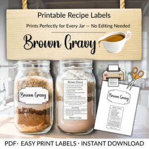 May include: Printable recipe labels for brown gravy. The image shows two jars of ingredients, a printed recipe, and a wooden sign. The sign reads "Printable Recipe Labels" and "Brown Gravy". A small gravy boat is also shown.