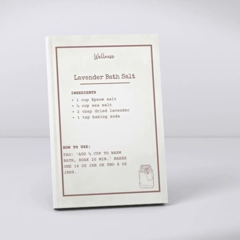 May include: A white rectangular card with a brown border featuring the text Wellness, Lavender Bath Salt, a list of ingredients including 1 cup Epsom salt, 1/4 cup sea salt, 2 tbsp dried lavender, 1 tsp baking soda, and instructions for use.