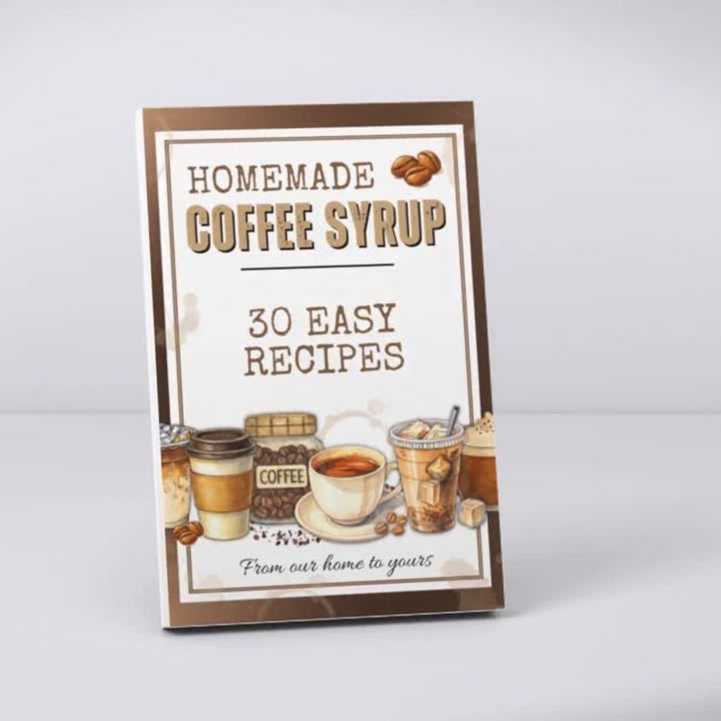 Peut inclure: Un livre rectangulaire intitul&eacute; HOMEMADE COFFEE SYRUP 30 EASY RECIPES avec une bordure marron. La couverture pr&eacute;sente des illustrations de diverses boissons au caf&eacute;, un bocal de grains de caf&eacute; et le texte From our home to yours.