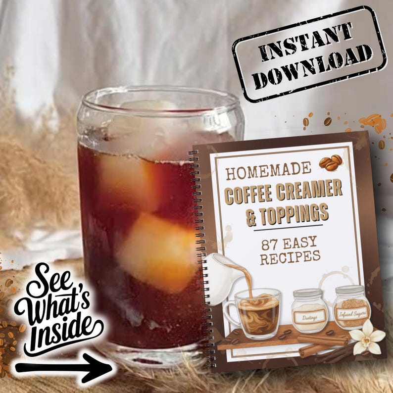 May include: A glass of iced coffee next to a spiral-bound book titled "Homemade Coffee Creamer & Toppings" with 87 easy recipes. The book features illustrations of coffee and ingredients. The image also includes the text "Instant Download" and "See What's Inside".