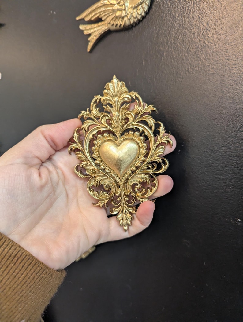 Gold sacred heart ex voto wall decor, baroque romantic style, Marie-Antoinette inspired, elegant curiosity cabinet.