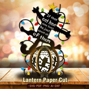 May include: A decorative lantern paper cut design featuring a black silhouette of a cat with the text "If that cat had nine lives, he just spent all of them." The lantern has a cat silhouette design and is decorated with colorful lights.