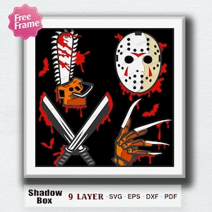 May include: A framed shadow box design featuring horror movie icons. The design includes a chainsaw, a hockey mask, crossed knives, and a bladed glove, all set against a black background with red blood splatter details. The text "Shadow Box" is at the bottom.