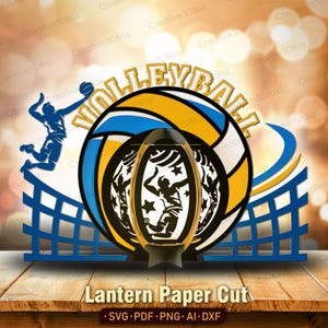 Puede incluir: Un diseño de corte de papel en capas con temática de voleibol. Incluye un balón de voleibol, una red y siluetas de jugadores. La palabra "VOLLEYBALL" está en la parte superior. El diseño es en azul, amarillo y blanco. El texto "Lantern Paper Cut" está en la parte inferior.