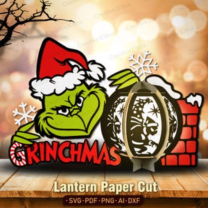 May include: A green Grinch-themed paper cut design with a red Santa hat and the word "GRINCHMAS". A lantern with a Grinch silhouette and a snowflake are also featured. The design includes the text "Lantern Paper Cut" and file type information.