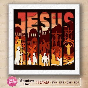 May include: A multi-layered shadow box art piece featuring the word "JESUS". The artwork uses shades of orange, brown, and yellow to depict biblical scenes. The design includes figures, crosses, and architectural elements, creating a 3D effect.