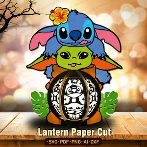 May include: A layered paper cut design featuring the characters Stitch and Grogu, with a lantern at the base. The lantern has a black frame with white cut-out designs. The text "Lantern Paper Cut" is at the bottom.