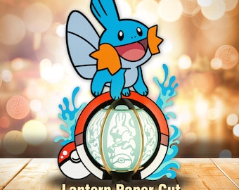 May include: A paper cut lantern featuring a blue and orange cartoon character atop a red and white ring with a white lantern. The lantern has a design inside. The words "Lantern Paper Cut" are at the bottom.