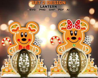 May include: Two gingerbread mouse lantern designs. The lanterns are made of gingerbread and feature a mouse holding a candy cane. The lanterns are decorated with white frosting and red candy hearts. The lanterns are set on a gingerbread house base.