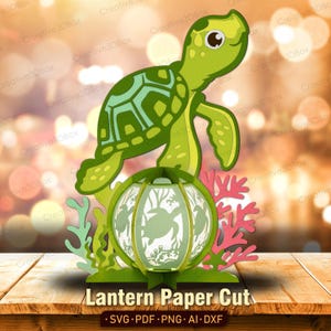 May include: A green paper cut lantern featuring a sea turtle design. The lantern has a spherical shape with cut-out turtle and underwater scenes. The design includes coral and seaweed accents. The text "Lantern Paper Cut" is at the bottom.