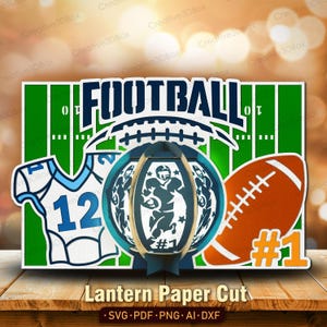 May include: A layered paper cut design featuring a football theme. The design includes a football field, a football, a jersey with the number 12, and a 3D football with a player. The text "FOOTBALL" is prominently displayed.