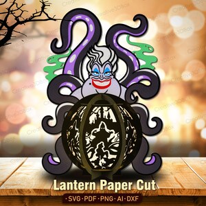 May include: A paper cut lantern featuring a cartoon depiction of Ursula from The Little Mermaid. The design includes purple tentacles, a smiling face, and a decorative lantern with the text "Lantern Paper Cut".