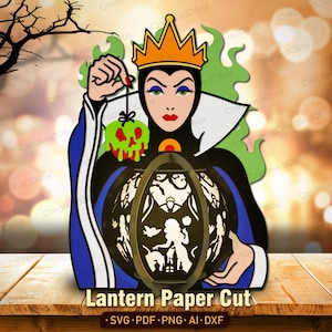 Puede incluir: Un dise&ntilde;o de corte de papel que presenta a una reina sosteniendo una linterna y una manzana envenenada. La reina lleva una corona y un vestido negro y azul. La linterna tiene un dise&ntilde;o de silueta. El texto "Lantern Paper Cut" est&aacute; en la parte inferior.
