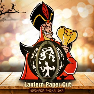 Puede incluir: Un dise&ntilde;o de corte de papel con un villano de dibujos animados con atuendo rojo y negro, sosteniendo una cobra dorada y una linterna negra con dise&ntilde;os recortados en blanco. El texto "Lantern Paper Cut" se muestra debajo.