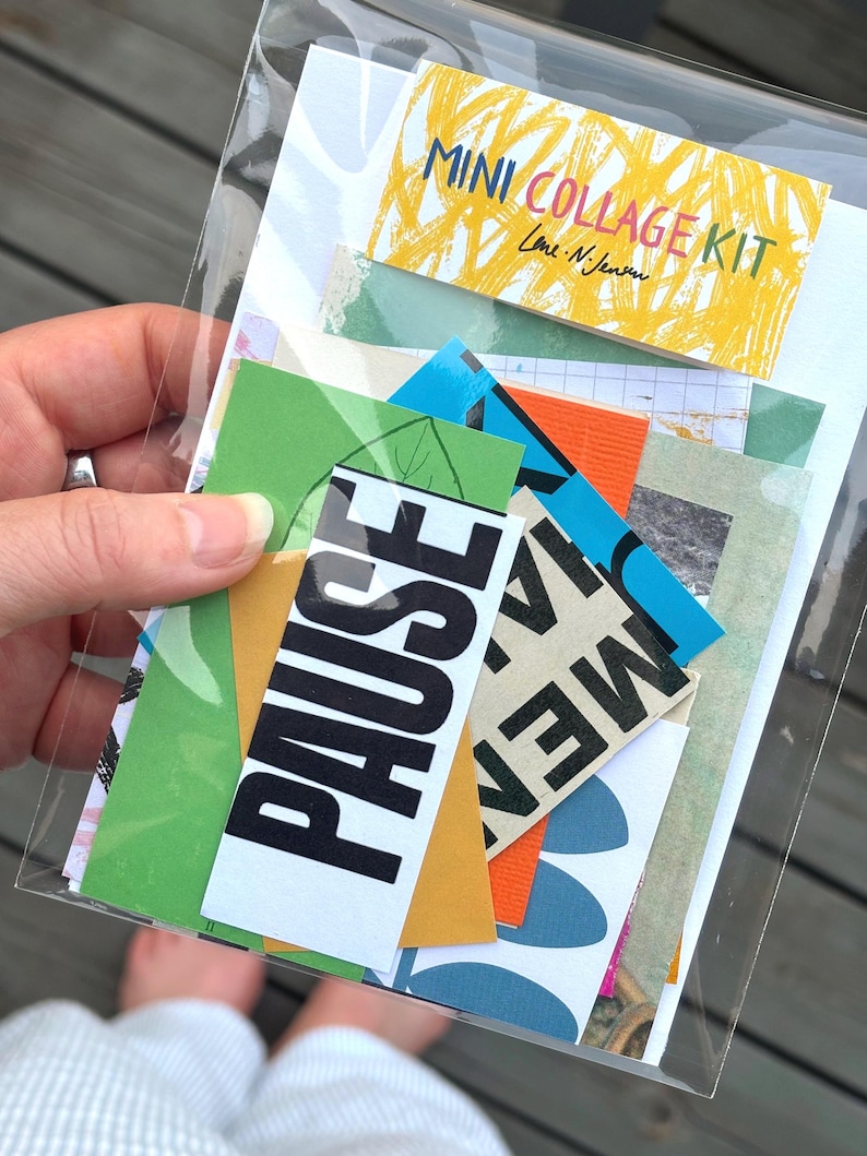 May include: A clear plastic bag containing a mini collage kit. The kit includes colorful paper scraps with text and designs, including the word "PAUSE" in large black letters. The kit's label reads "MINI COLLAGE KIT."