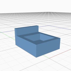 May include: A light blue, rectangular box with a raised back panel. The box is empty and has a smooth surface.