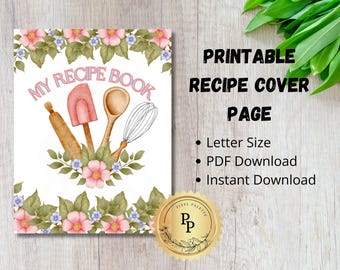 May include: Printable recipe book cover page with a pink, white, and green floral design. The text "MY RECIPE BOOK" is in pink letters. There are three kitchen utensils: a rolling pin, a spatula, and a whisk.