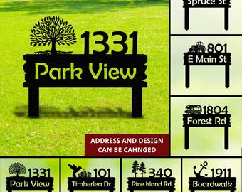 May include: A collection of eight different yard signs with various designs and text. The signs are black and feature a variety of designs, including a tree, a car, a camper, a hummingbird, a palm tree, and an anchor. The signs also include text such as "Park View", "Spruce St", "E Main St", "Forest Rd", "Timberlea Dr", "Pine Island Rd", and "Boardwalk".