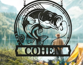 May include: Black metal sign featuring a fish jumping out of the water, with a fishing rod and reel design. The sign is personalized with the name "COHEN" and hangs from chains. The background shows a person fishing near a lake and a tent.