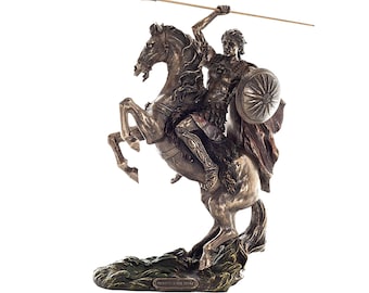May include: Bronze-colored statue of a man on a rearing horse, holding a spear and shield. The statue depicts a historical figure, possibly a warrior or leader, with detailed armor and a flowing cape. The base of the statue has a textured, green appearance.