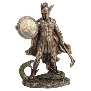 May include: Bronze statue of Perseus, a Greek hero, holding a shield with Medusa's image and a curved sword. He stands atop a serpent, wearing a helmet and armour. The statue has a red cape and is a decorative item.