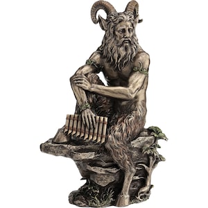 May include: A detailed statue of a seated satyr with horns, a beard, and a flute. The figure is depicted with a human upper body and the lower body of a goat, resting on a rocky base. The statue is painted in shades of brown and gray.