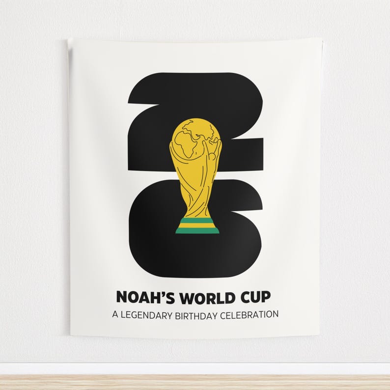May include: A white wall tapestry featuring a large black number 26 with a yellow and green trophy illustration centered inside. Below the graphic, the text reads NOAH'S WORLD CUP and A LEGENDARY BIRTHDAY CELEBRATION in bold black capital letters.