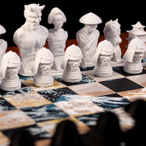 May include: A white chess set with Japanese-inspired pieces on a chessboard with a wave pattern. The pieces include a demon, a geisha, a samurai, and a pagoda.